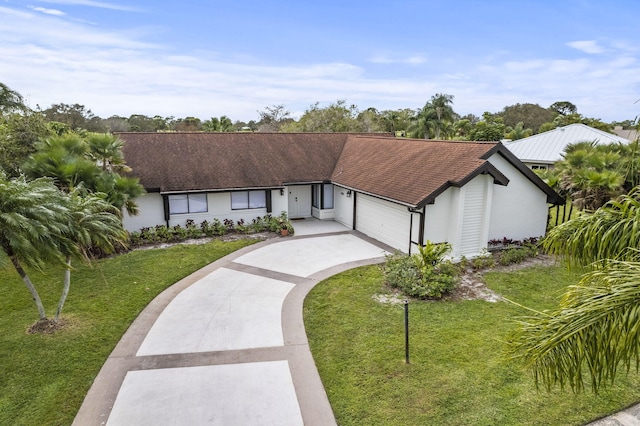 ranch-style house featuring a garage and a front yard