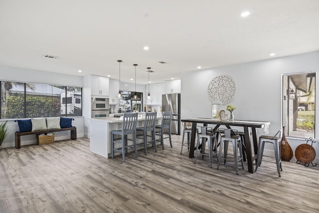 dining space with hardwood / wood-style floors