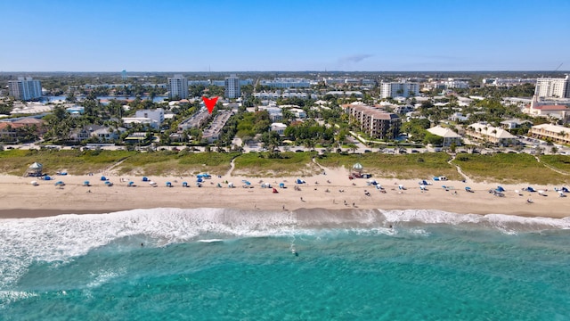 birds eye view of property featuring a view of the beach and a water view