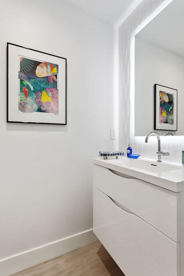 bathroom with vanity and hardwood / wood-style flooring