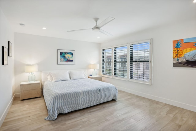 bedroom with ceiling fan and light hardwood / wood-style flooring