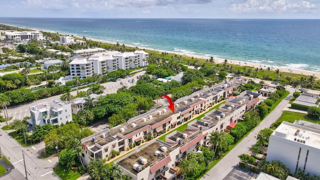 bird's eye view with a water view and a beach view