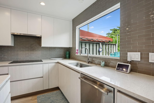 kitchen with dishwasher, a healthy amount of sunlight, sink, and black electric stovetop