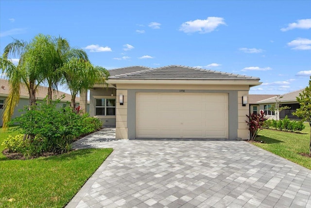 view of front of property featuring a garage and a front yard