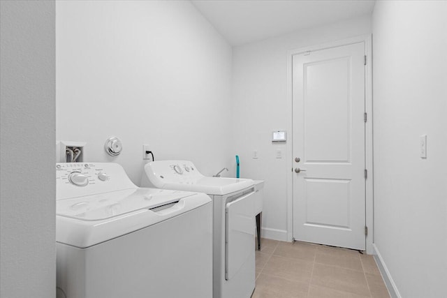 laundry area with light tile patterned flooring and separate washer and dryer