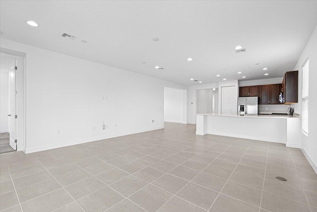 unfurnished living room with light tile patterned floors