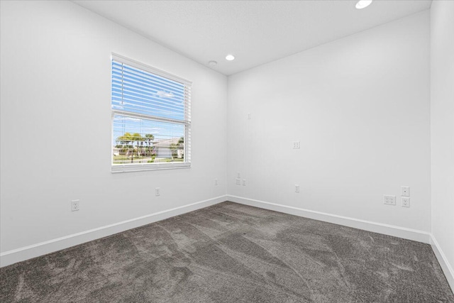 empty room with dark carpet