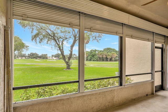 unfurnished sunroom with a healthy amount of sunlight and view of golf course