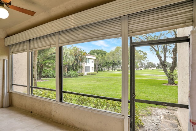 unfurnished sunroom featuring ceiling fan