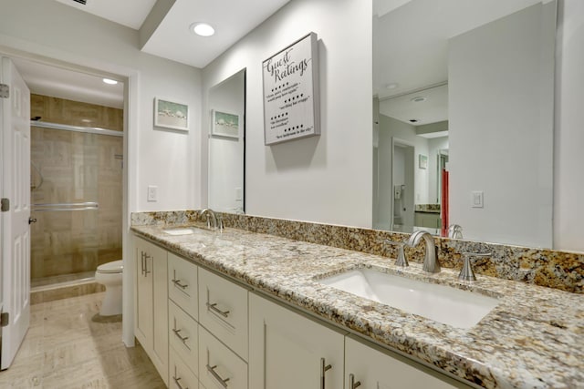 bathroom featuring tile patterned flooring, toilet, walk in shower, and vanity