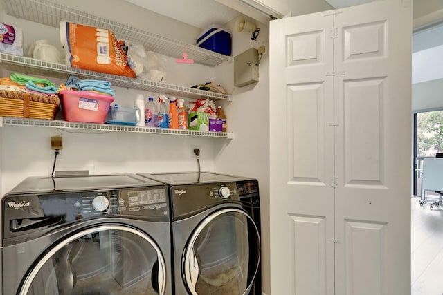 clothes washing area featuring hardwood / wood-style flooring and separate washer and dryer