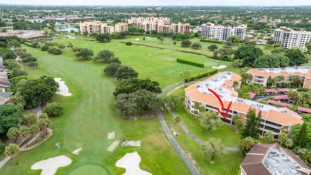 drone / aerial view featuring a city view, a water view, and view of golf course