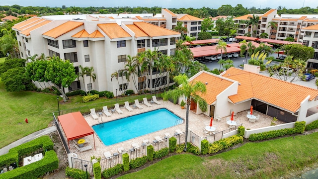 view of swimming pool featuring a patio and a yard