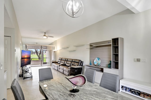 tiled dining space with ceiling fan with notable chandelier