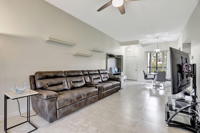 living room with light tile patterned floors and ceiling fan with notable chandelier