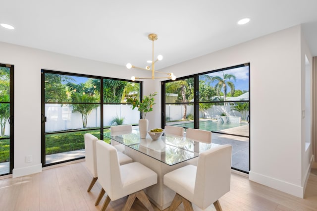 dining room featuring light hardwood / wood-style flooring and an inviting chandelier