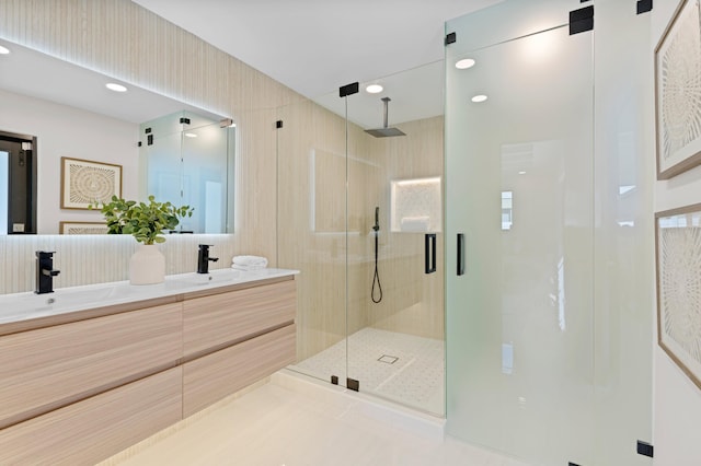 bathroom featuring walk in shower, vanity, and tile patterned floors