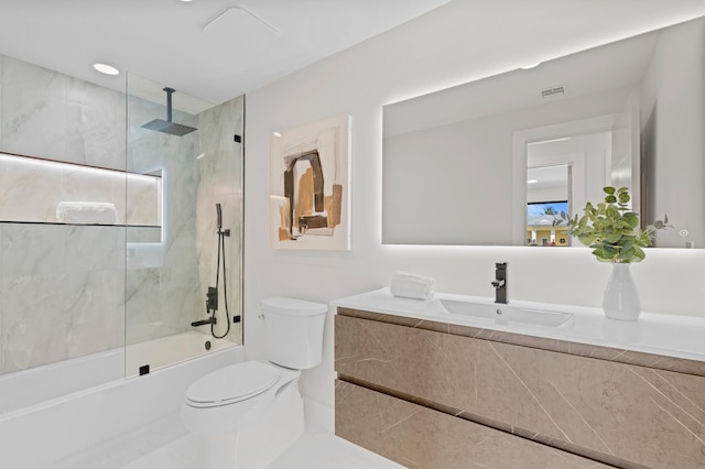 full bathroom with tiled shower / bath combo, tile patterned flooring, vanity, and toilet