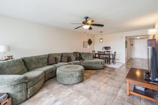 living room with ceiling fan and light tile patterned floors