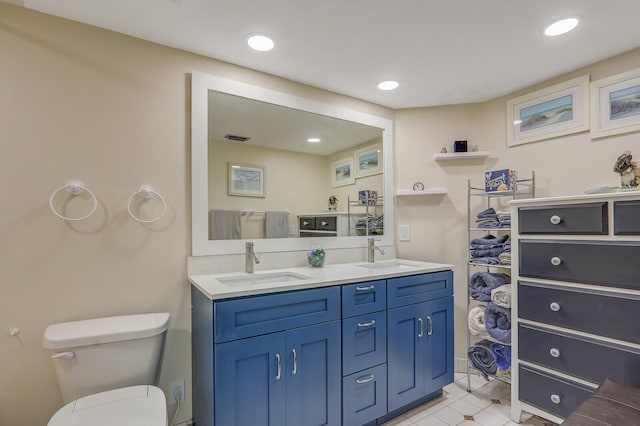 bathroom with vanity, toilet, and tile patterned floors