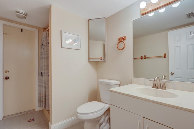 bathroom with a shower with curtain, vanity, toilet, and tile patterned floors