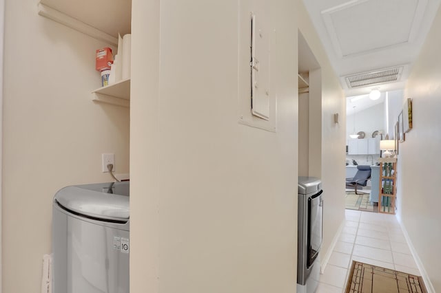 hallway with light tile patterned floors and washing machine and dryer