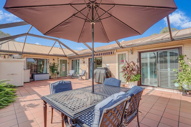 view of patio featuring glass enclosure