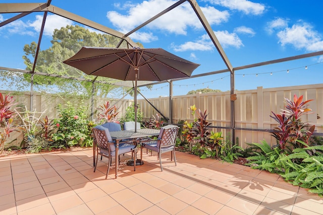 view of patio featuring a lanai