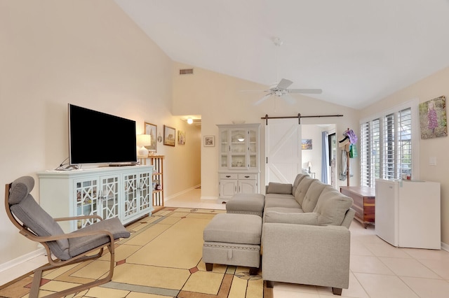 tiled living room with lofted ceiling, ceiling fan, and a barn door