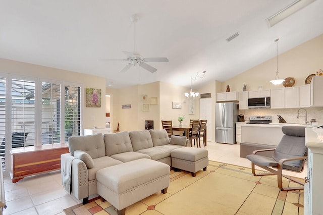 tiled living room featuring ceiling fan with notable chandelier, sink, and high vaulted ceiling