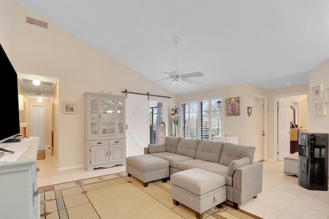 tiled living room featuring a barn door, ceiling fan, and high vaulted ceiling