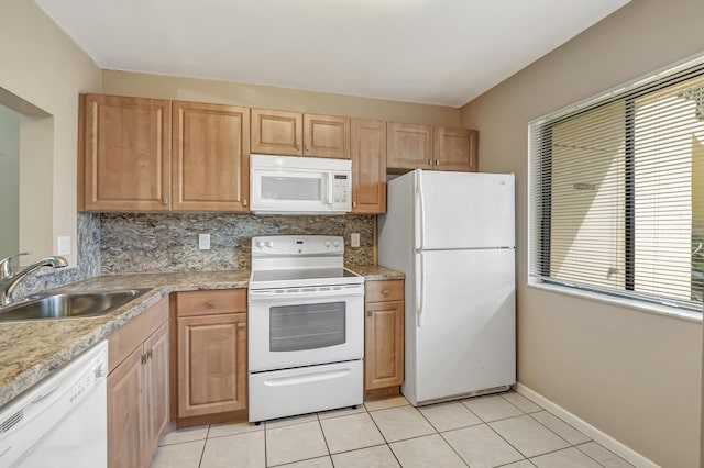 kitchen featuring sink, light tile patterned floors, white appliances, and tasteful backsplash