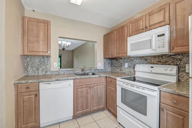 kitchen with backsplash, sink, white appliances, and light tile patterned flooring