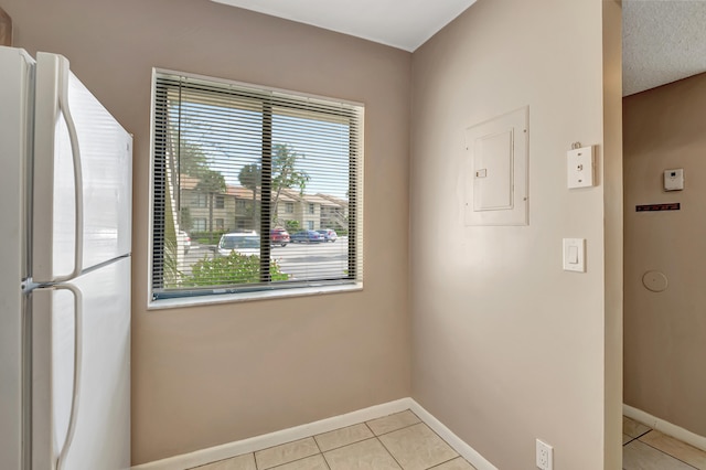 interior space featuring light tile patterned floors and electric panel