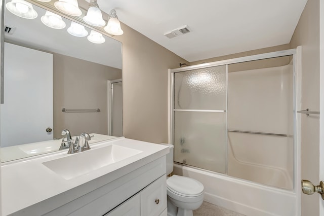 full bathroom with vanity, toilet, tile patterned floors, and bath / shower combo with glass door