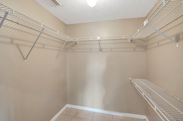 spacious closet with light tile patterned flooring