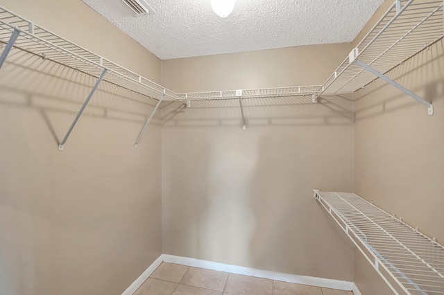 walk in closet with visible vents and tile patterned floors