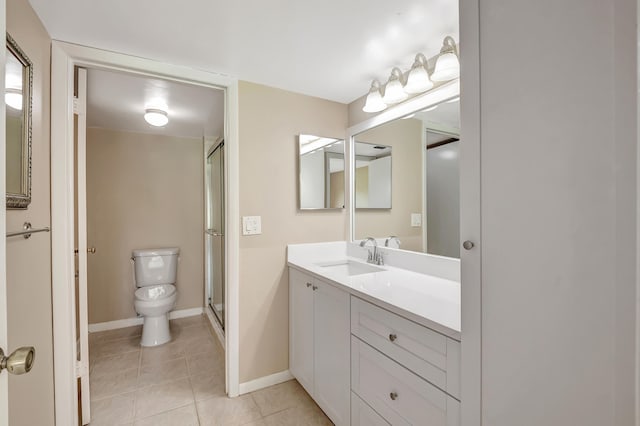 bathroom featuring vanity, toilet, an enclosed shower, and tile patterned floors