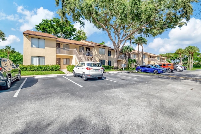 uncovered parking lot featuring a residential view