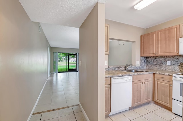 kitchen featuring light tile patterned floors, light brown cabinets, white appliances, a sink, and light countertops