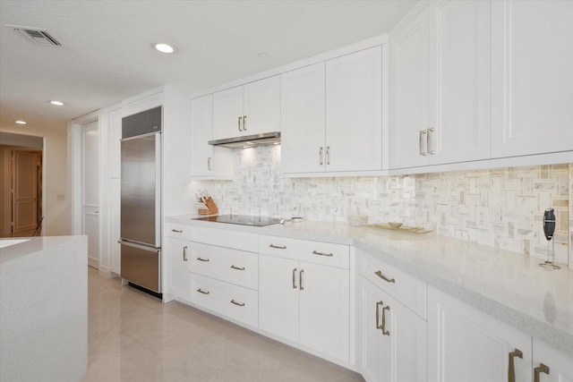 kitchen featuring white cabinetry and built in fridge