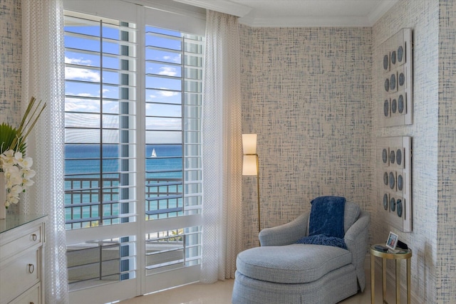 sitting room with ornamental molding and a water view