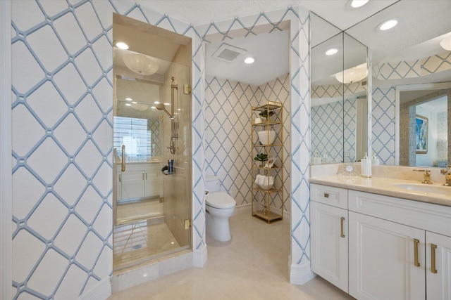 bathroom featuring toilet, vanity, and walk in shower