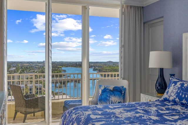 bedroom with ornamental molding and a water view