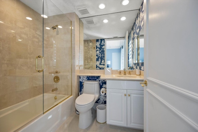 full bathroom featuring vanity, toilet, and combined bath / shower with glass door