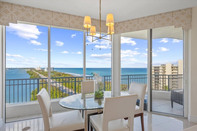 sunroom with a water view, plenty of natural light, and a chandelier