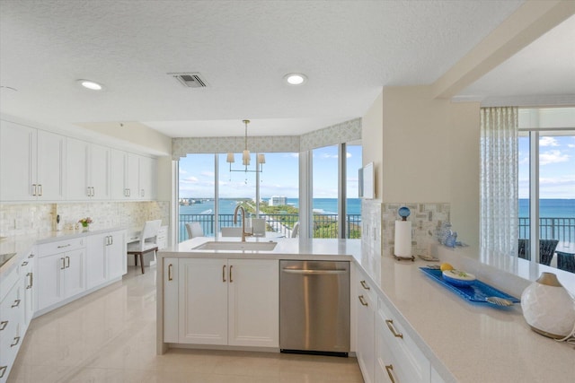 kitchen with a water view, dishwasher, sink, and white cabinets