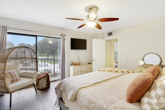 bedroom with hardwood / wood-style flooring, access to outside, and ceiling fan