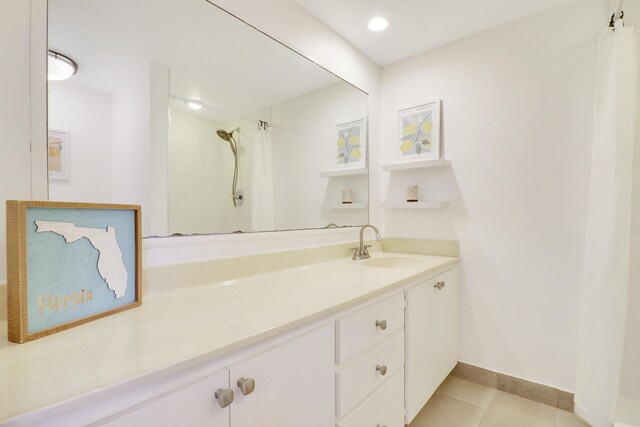 bathroom with tile patterned floors, a shower with curtain, and vanity