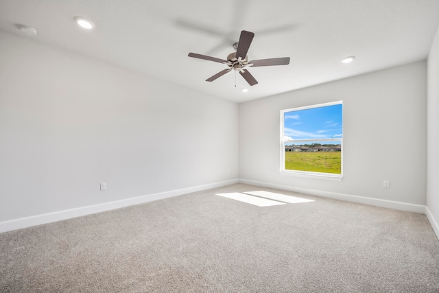 empty room featuring ceiling fan and carpet